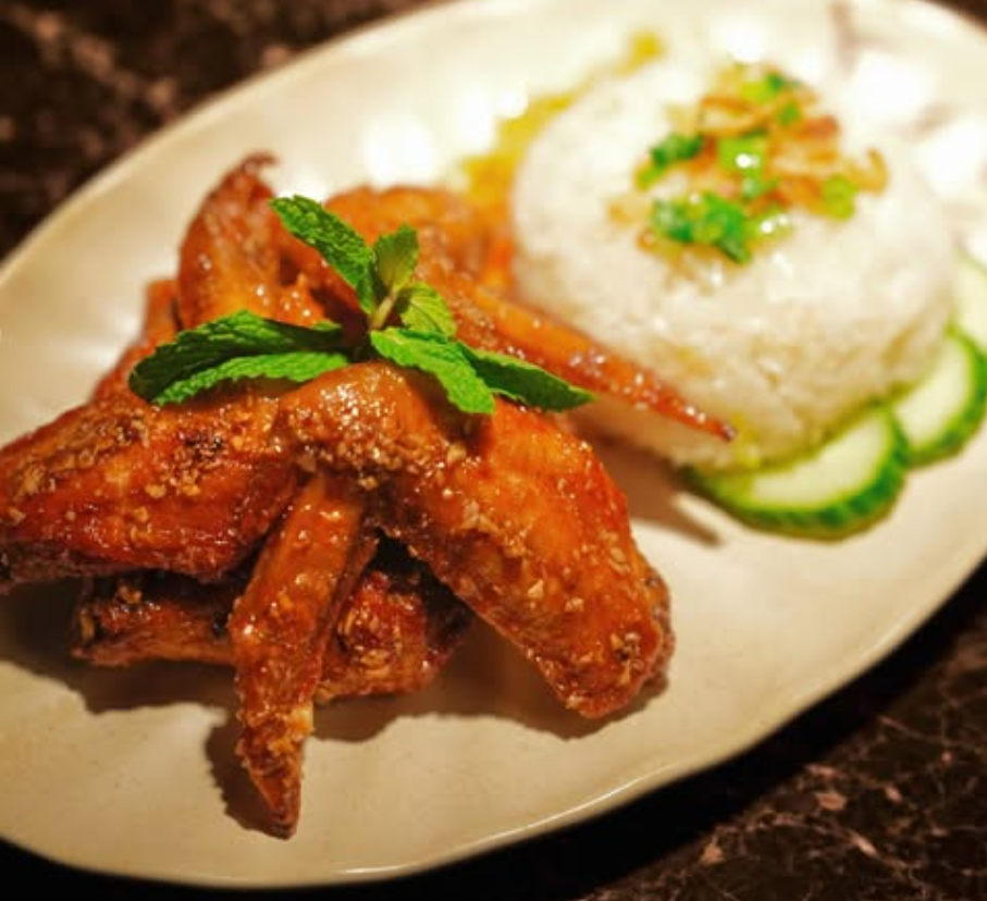 Crispy Vietnamese spring rolls plated with herbs and dipping sauce
