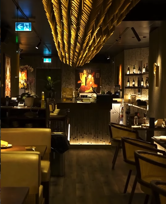 Warm restaurant bar with golden lighting, wood textures, and premium cocktails